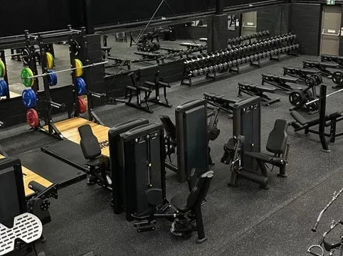 Modern gym with weightlifting and fitness equipment for all levels.