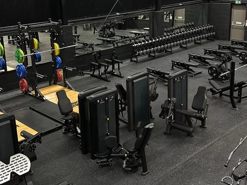 Modern gym with weightlifting and fitness equipment for all levels.