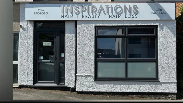 Modern exterior of Inspirations Hair, Beauty & Hair Loss salon in Fleckney, featuring a grey textured facade, black window frames, and a glass door.