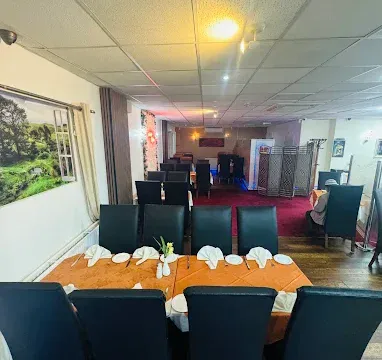 Spacious dining area with elegant table settings and comfortable chairs at Fleckney.Today. Perfect for family meals, gatherings, and special occasions in Fleckney.