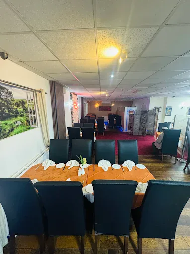 Spacious dining area with elegant table settings and comfortable chairs at Fleckney.Today. Perfect for family meals, gatherings, and special occasions in Fleckney.